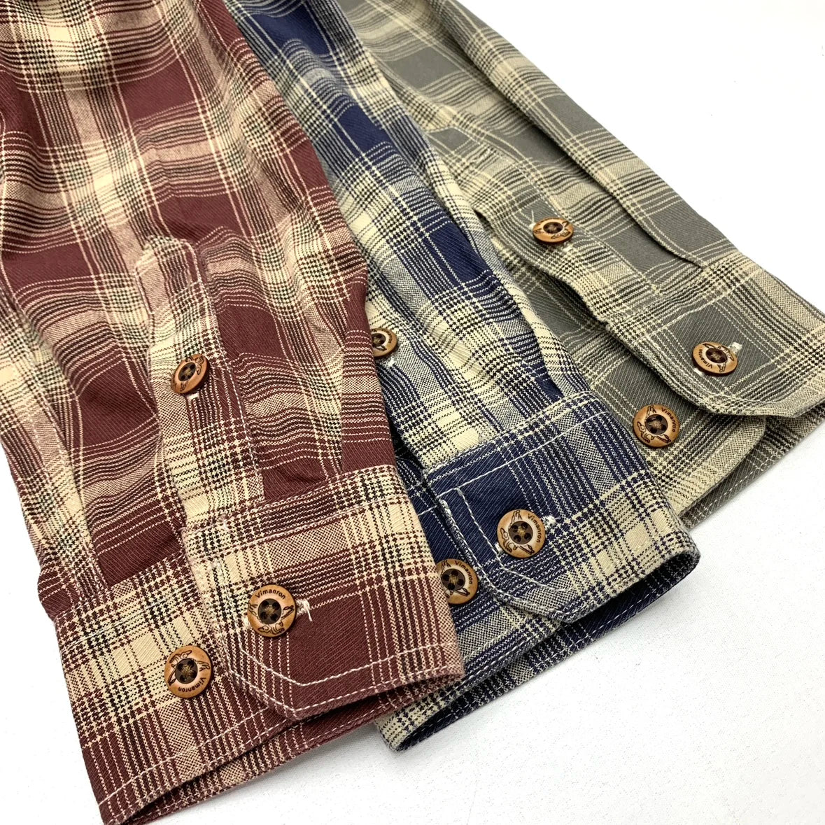 Close-up of the cuffs and wooden buttons in the three plaids