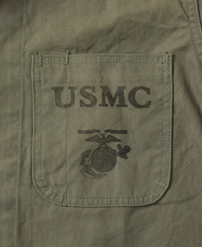 Macro of the chest pocket with the printed military stencil on the herringbone twill