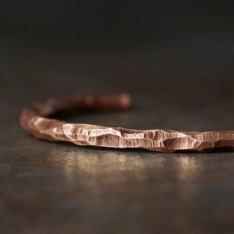 Macro of the hand hammered facets on the copper cuff