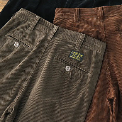 Buttoned back pocket with woven label on the Dark Olive corduroy trousers