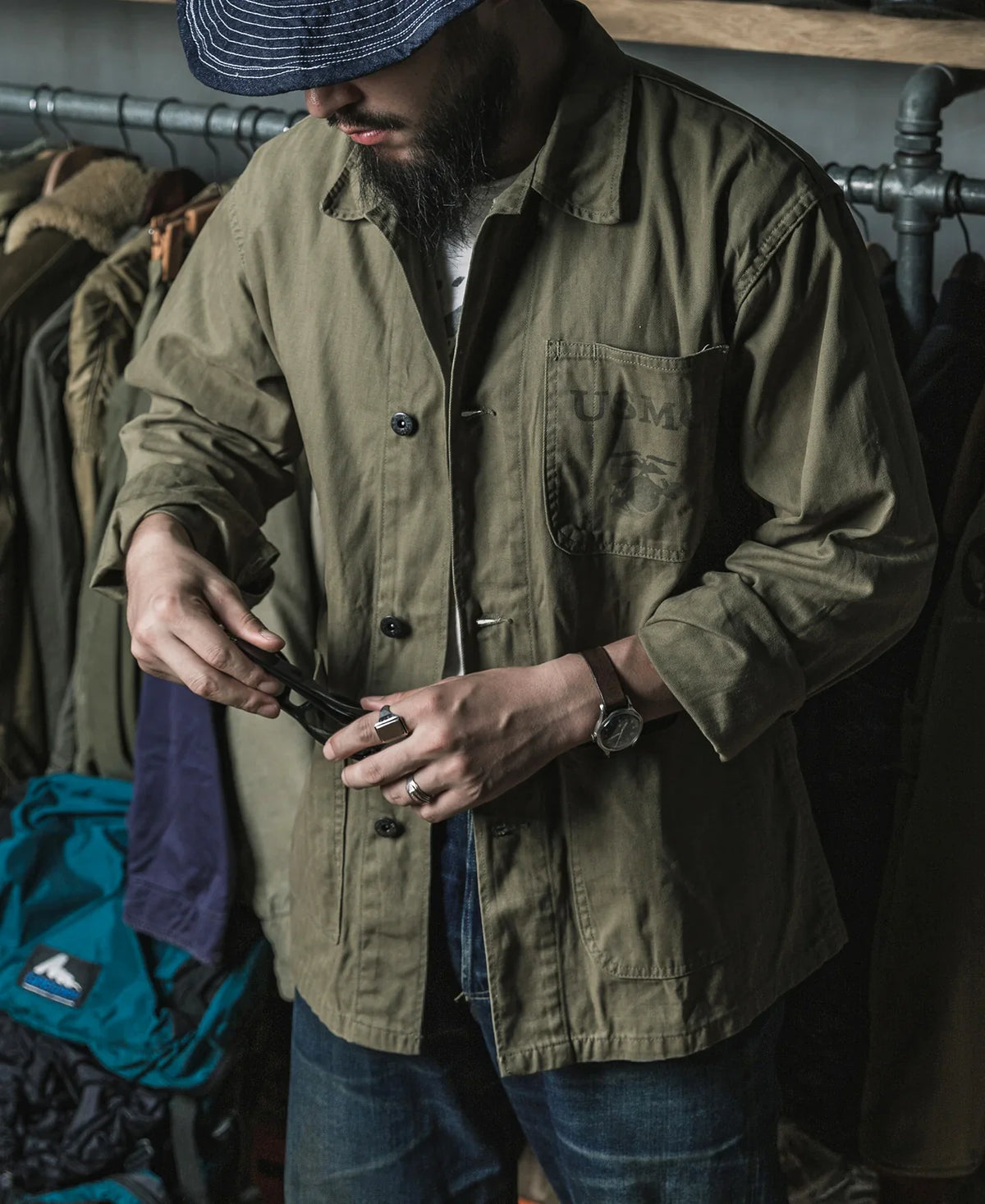 Man buttoning the P41 jacket, showing the straight cut and patch pockets