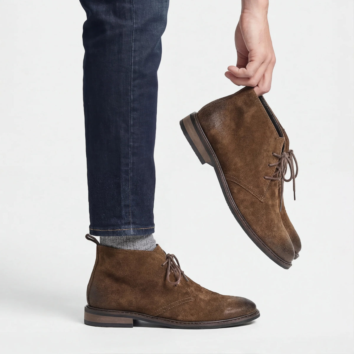 Pampa Suede Chukka Boot worn with dark jeans, holding the pair