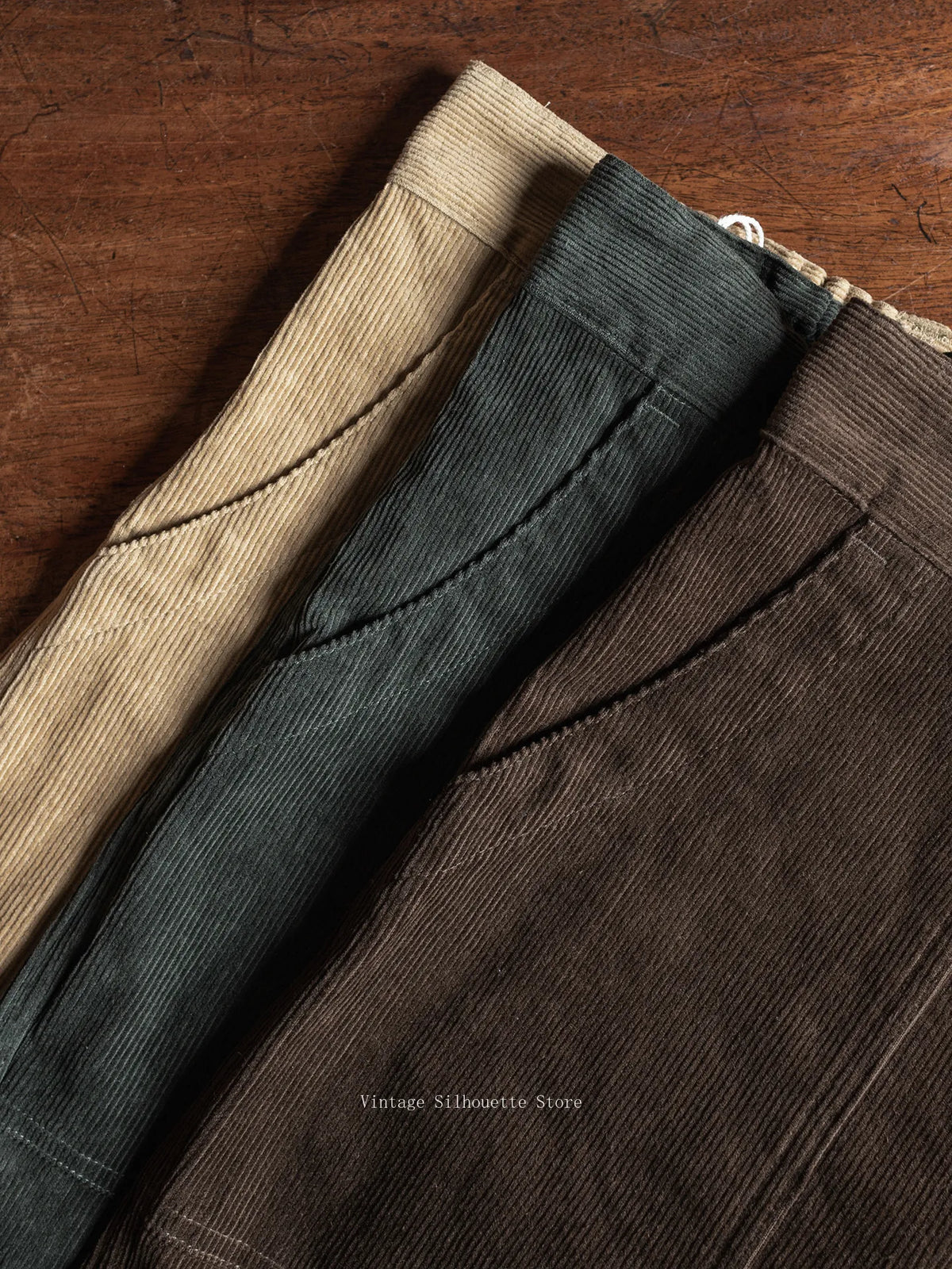 Close-up of the front pocket and waistband in Coffee and Dark Green