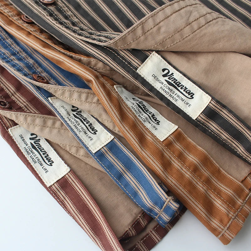 Collars and woven inside labels of the four cabana shirts laid side by side