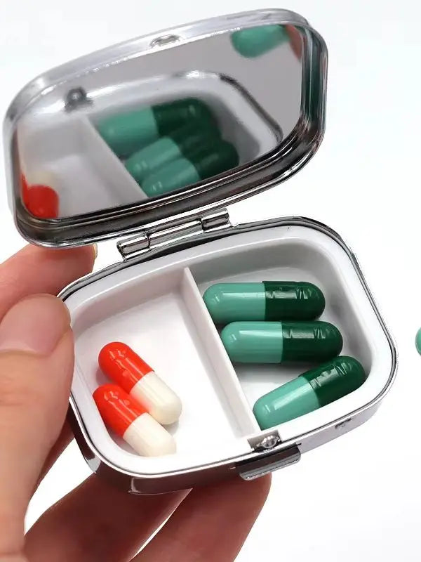 Open tin showing the two compartments and the mirror in the lid