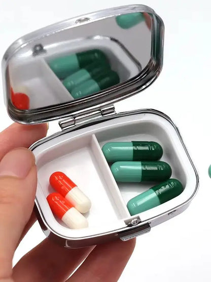 Open tin showing the two compartments and the mirror in the lid