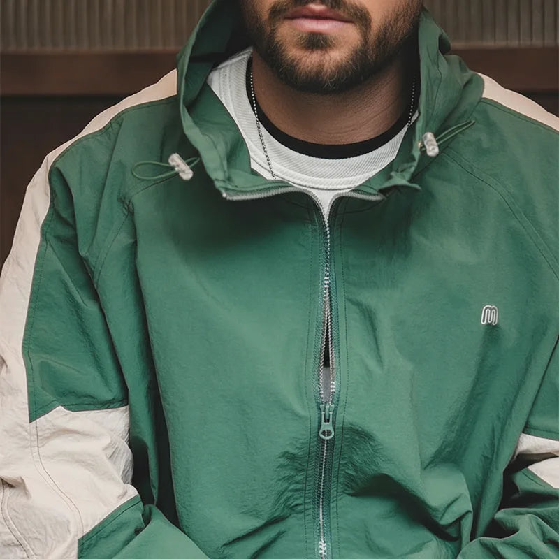 Close-up of the high collar and the double zipper on the Expedition Green windbreaker