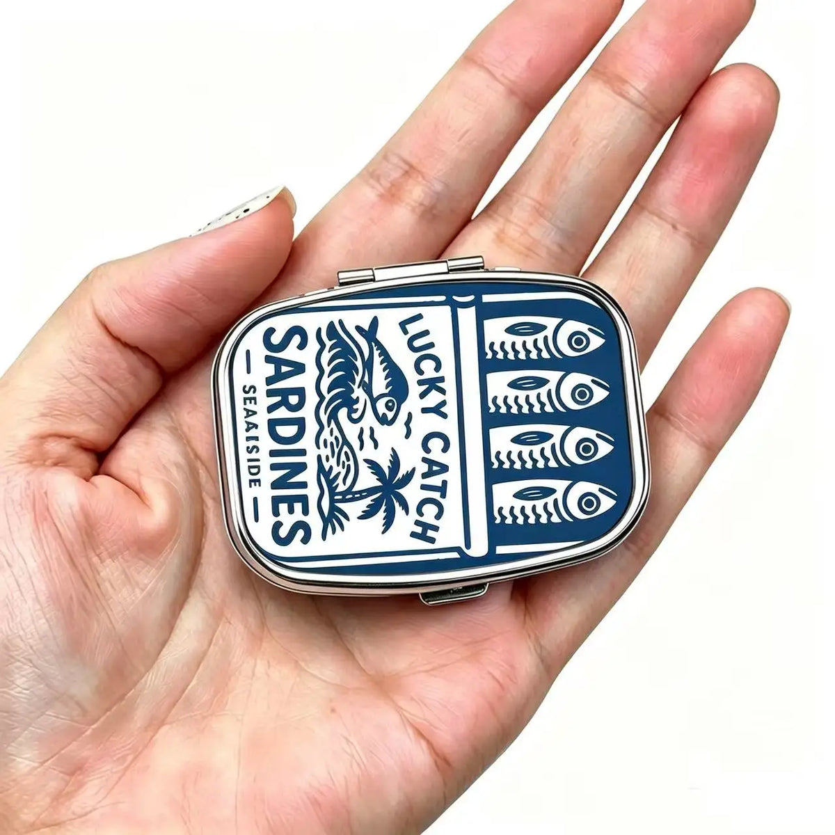 Tin held in the hand to show its pocket size