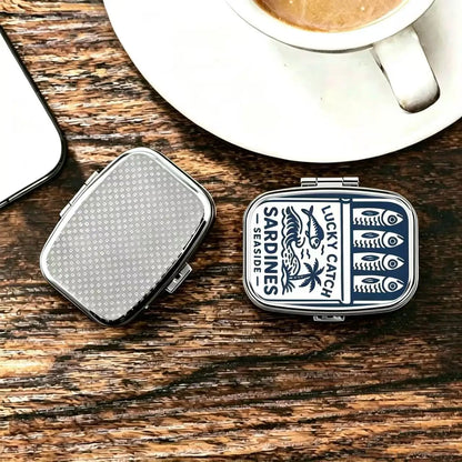 Two tins on a wooden surface, one showing the printed lid and one the textured metal back