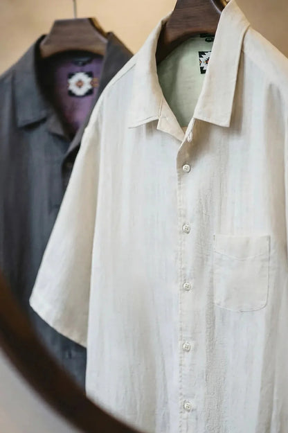 Light Sand shirt on a hanger showing the open Cuban collar and linen texture