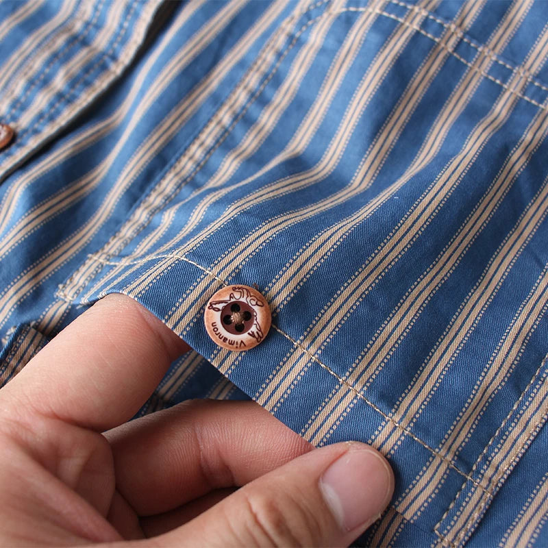 Macro of the pleated sleeve cuff with resin button on the Blue stripe