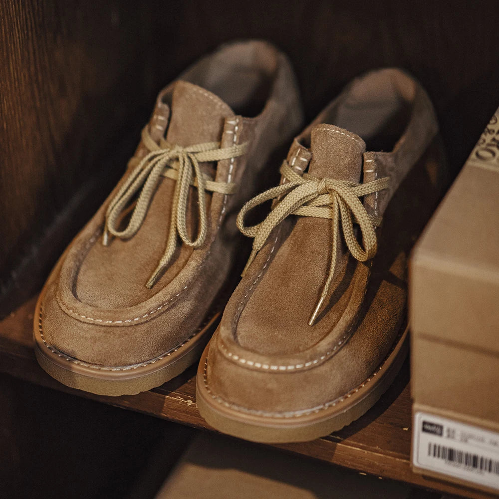 Suede Desert Shoe in khaki on a wooden shelf