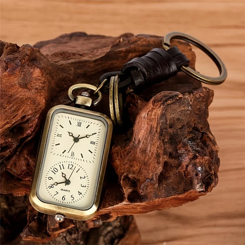 Bronze Pocket Watch Keychain resting on wood, detail of the dials